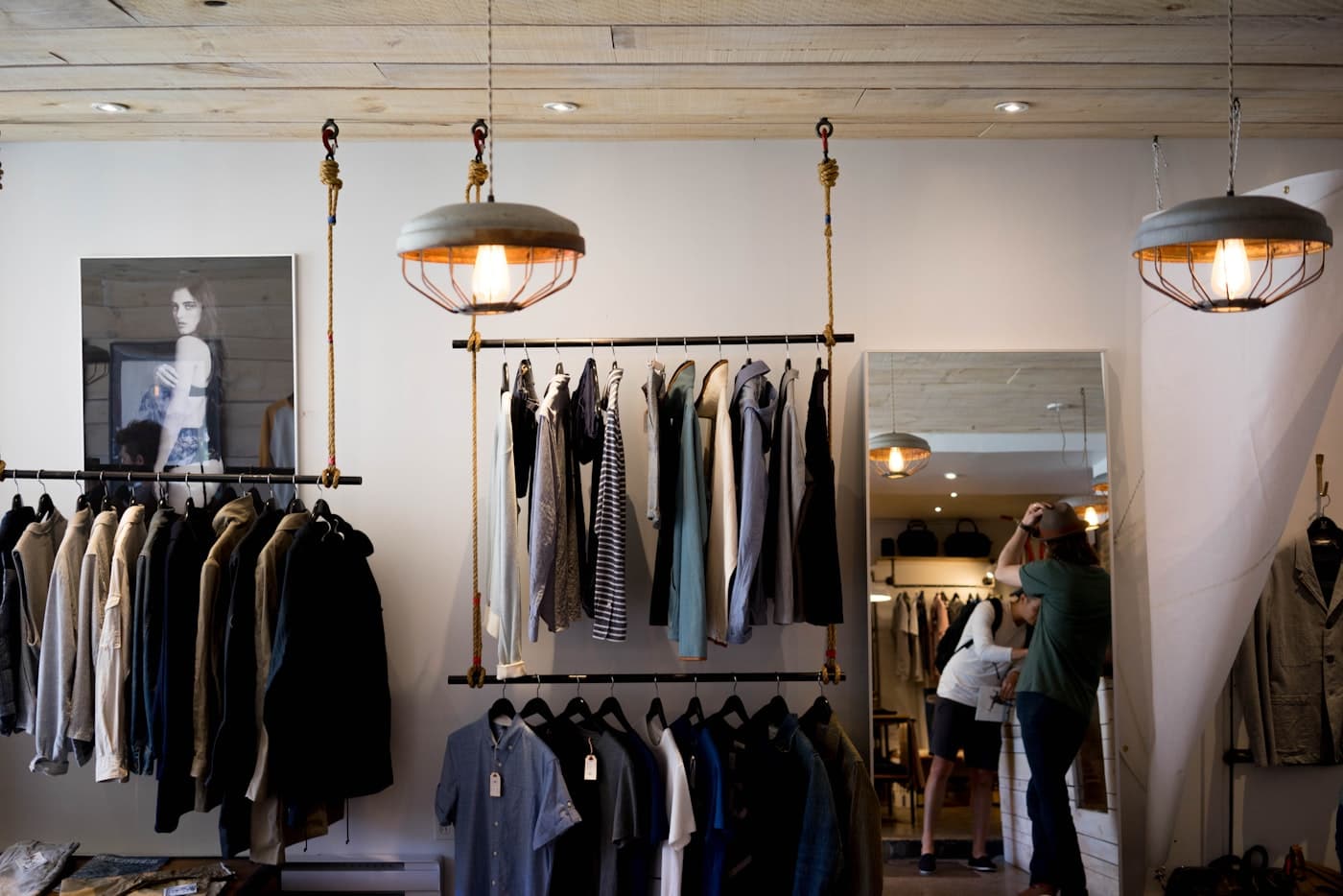 Independent boutique clothing racks under pendant lights